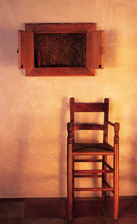 Neighbor and cabinetmaker Mike Mooney made the frame and doors for the traditional “truth window” out of old oak fence board from the property. Behind the doors, curious visitors can actually touch the uncovered straw.